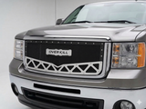 Silver truck with a custom grille featuring 'Over Kill' branding on a white background