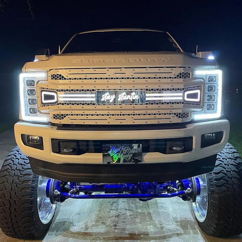 Custom LED grille replacement for a Ford Super Duty truck, featuring a stainless steel mesh design with LED lighting, mounted on the front of the vehicle.