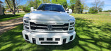 Front grille of a white Ford Super Duty truck with customizable center text and a unique mesh design pattern.